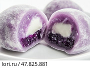Purple Mochi Traditional Japanese Rice Dessert. Delicious moti. Close up. Asian daifuku sweet. Cut in half with filling. Colorful Mochi Assortment. Colorful cake. Fukashi manju. Culinary delights. Стоковое AI-изображение, AI-художник Марина Демидюк / Фотобанк Лори