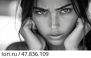 A young woman displays a powerful expression with furrowed brows and piercing eyes while holding her face in a thoughtful pose. Стоковое AI-изображение, AI-художник Данила Большаков / Фотобанк Лори
