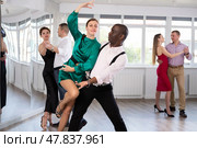 Middle-aged man and woman practicing waltz in dancing studio. Стоковое фото, фотограф Яков Филимонов / Фотобанк Лори