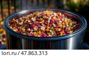 A vibrant mix of chopped vegetables sits steaming in a large pot, ideal for a communal outdoor meal during autumn festivities. Стоковое AI-изображение, AI-художник Данила Большаков / Фотобанк Лори
