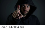 Mysterious lowkey portrait of a confrontational figure in a hooded sweatshirt. Стоковое AI-изображение, AI-художник Андрей Бакусов / Фотобанк Лори