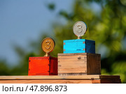Third place trophies are displayed on vibrant podiums under a clear blue sky, capturing the spirit of achievement in a sunny location. Стоковое AI-изображение, AI-художник Данила Большаков / Фотобанк Лори