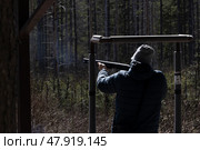 Стендовая стрельба. Мужчина с ружьем стреляет по тарелкам. Редакционное фото, фотограф Дарджания Зураб / Фотобанк Лори