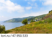 Beautiful landscape of coast of Baikal Lake. View of the village of Port-Baikal on the shore lake with flowers field on a sunny summer day. Circum-Baikal Railway station. Travel and outdoor recreation. Стоковое фото, фотограф Виктория Катьянова / Фотобанк Лори