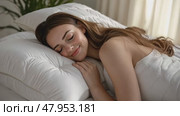 Young woman sleeping in bed. Caucasian attractive girl hugging soft white pillow. Happy Lady enjoys fresh soft bedding linen, mattress in bedroom lying closed eyes. Good sleep concept. Sunny morning. Стоковое AI-видео, аниматор Марина Демидюк / Фотобанк Лори