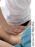 Relaxing massage and body shaping massage, lymphatic drainage, manual and aesthetic procedures, hands massaging belly in the spa salon. Стоковое фото, фотограф Роготнева Виктория / Фотобанк Лори