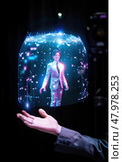 During a technology demonstration, an individual in a silver suit engages with a mesmerizing holographic display projecting a stunning visual. Стоковое AI-изображение, AI-художник Данила Большаков / Фотобанк Лори