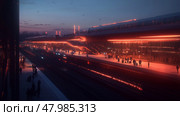 Evening commuters wait at a modern railway station illuminated by vibrant lights as dusk settles in. Стоковое AI-изображение, AI-художник Сергей Толмачёв / Фотобанк Лори