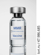 Vaccination for revaccination against measles, mumps and rubella. Medicine and healthcare concept. MMR campaign. Doctor with a vial of measles, mumps and rubella vaccine doses. 3d render. Стоковая иллюстрация, иллюстратор Alexander / Фотобанк Лори