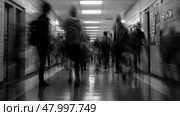 A somewhat blurry hospital corridor filled with numerous people walking about on their various errands and duties. Стоковое AI-изображение, AI-художник Anastasy Yarmolovich / Фотобанк Лори