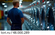 A person is focused on the washing machines in a bright laundromat at night, surrounded by the hum of appliances and folded clothes. Стоковое AI-изображение, AI-художник Данила Большаков / Фотобанк Лори