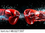 two boxing gloves clashing in a test. Стоковое фото, фотограф Anastasy Yarmolovich / Фотобанк Лори