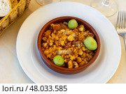 Migas pastoriles from fried bread crumbs with chorizo, bacon and grapes. Стоковое фото, фотограф Яков Филимонов / Фотобанк Лори
