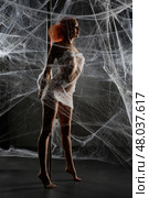 Red woman entangled in a delicate net trap with striking beauty. Стоковое фото, фотограф Гурьянов Андрей / Фотобанк Лори