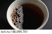 Pouring Fresh Coffee into a Cup, capturing the moment where liquid comfort meets elegance. Стоковое фото, фотограф David Kashakhi / Фотобанк Лори