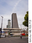 Shanghai, China – 1 April 2025: Contemporary Chinese architecture in central Shanghai, with a unique stepped tower and modern urban design under a cloudy sky. Редакционное фото, фотограф Татьяна Терехина / Фотобанк Лори