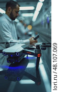 A close-up of a worker assembling a drone on a high-tech production line, with neon blue accents and sleek machinery in the background. Стоковое AI-видео, аниматор Sergey Grishin / Фотобанк Лори