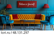 A cozy living room features an orange tufted sofa with colorful cushions, blue chairs, and motivational art on a vibrant wall in a stylish setting. Стоковое AI-изображение, AI-художник Данила Большаков / Фотобанк Лори