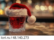 Festive drink adorned with a Santa Hat celebrating joyful occasions, copy space. праздничный напиток, украшенный шапкой Санта-Клауса в честь радостных событий, место для копирования. Стоковое AI-изображение, AI-художник Katsiaryna Repich / Фотобанк Лори