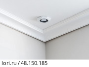 Ceiling close-up. Classic interior. LED Retrofit Bulb into Ceiling Fixture. Cornice. Installing. Decorative Ceiling crown molding intersection. Wall Corner Architecture Decor. Angular ceiling skirting. Стоковое AI-изображение, AI-художник Марина Демидюк / Фотобанк Лори