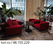 Интерьер лобби отеля  с красными диванами, гостиница Radisson Blu Leninsky Prospect Hotel  Москва. Редакционное фото, фотограф Мария Сергеева / Фотобанк Лори