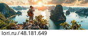 A hiker enjoys the breathtaking sunset over Ha Long Bay while capturing the stunning landscape with a camera. Стоковое AI-изображение, AI-художник Данила Большаков / Фотобанк Лори
