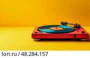 Vintage Groove: Red Turntable with Teal Record on Radiant Yellow Backdrop. Стоковое AI-изображение, AI-художник Данила Большаков / Фотобанк Лори