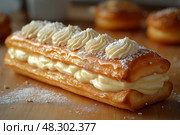 Delicious cream-filled pastries topped with colorful sprinkles and chocolate. пирожное с кремовой начинкой, усыпанные разноцветными посыпками и шоколадом. Стоковое AI-изображение, AI-художник Katsiaryna Repich / Фотобанк Лори