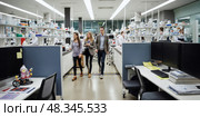 People walk across the modern laboratory. Intentional motion blur. Out of focus. Scientific workplace. Стоковое AI-изображение, AI-художник Катерина Ковалева / Фотобанк Лори