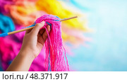 Crafting Fun: Handmaking Vibrant Yarn Tassels on a Stick. Стоковое AI-изображение, AI-художник Данила Большаков / Фотобанк Лори