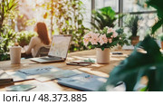 A sunlit workspace showcases a laptop, blooming flowers, and greenery, creating a relaxing atmosphere for productivity and creativity. Стоковое AI-видео, аниматор Данила Большаков / Фотобанк Лори