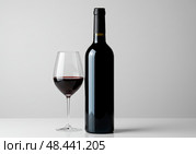 Red wine bottle, glass set elegant. This elegant drink for simple elegant joy. Стоковое AI-изображение, AI-художник Броницкая Галина / Фотобанк Лори