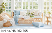 Coastal Serenity: Rattan Furniture in a Light-Filled Living Area for Relaxation and Calm. Стоковое AI-изображение, AI-художник Данила Большаков / Фотобанк Лори