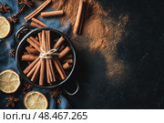 Cinnamon background. Pile of cinnamons stick top view. Cinnamomum cassia close up. Spice for the Holidays. Assortment of spices. Cinnamon bark is a spice used for sweet and savory dish. Стоковое AI-изображение, AI-художник Марина Демидюк / Фотобанк Лори