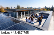 Solar panels on the roof of an energy-efficient school building, surrounded by students. Aerial view of the solar panels on the roof. modern buildings with classrooms and student residences. Стоковое AI-изображение, AI-художник ALLA YURTAYEVA / Фотобанк Лори