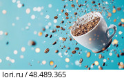 Morning Ritual: Coffee beans and grounds swirling around a tilting cup, in a dynamic explosion against a serene turquoise setting. Стоковое AI-изображение, AI-художник Данила Большаков / Фотобанк Лори