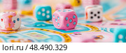 Game night: colorful dice scattered on a playful boardgame for family fun and strategic gameplay. Стоковое AI-изображение, AI-художник Данила Большаков / Фотобанк Лори