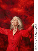 Elderly woman wearing a red shirt is extending her arms outwards. Стоковое AI-изображение, AI-художник Данила Большаков / Фотобанк Лори