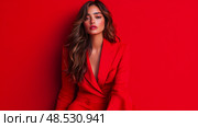 Crimson Charm: A sultry portrait of a brunette woman in a scarlet suit against a matching ruby backdrop. Стоковое AI-изображение, AI-художник Данила Большаков / Фотобанк Лори