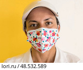 Celebrating health a woman in a floral mask against a bright yellow background. Стоковое AI-изображение, AI-художник Екатерина Борисова / Фотобанк Лори