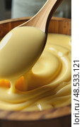 A close-up of a farmer hands churning butter dough in a traditional wooden churn, the golden cream swirling rhythmically. Стоковое AI-видео, аниматор Sergey Grishin / Фотобанк Лори