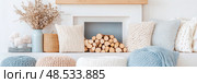 Cozy Fireplace Mantel Decor with Knitted Pillows and Firewood. Стоковое AI-изображение, AI-художник Данила Большаков / Фотобанк Лори