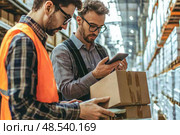 Two men in orange vests are looking at a box on a pallet. Стоковое AI-изображение, AI-художник Ярославский Максим / Фотобанк Лори