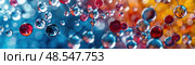 A myriad of translucent balls in red and blue hues float with a bokeh effect. Стоковое AI-изображение, AI-художник Данила Большаков / Фотобанк Лори