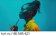 African American young woman is holding a paintbrush in her right hand. Стоковое AI-изображение, AI-художник Данила Большаков / Фотобанк Лори