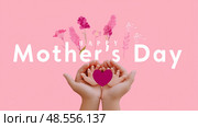 Hands holding a heart celebrates love and gratitude on Mother's Day with floral decorations in soft pink background. Стоковое AI-изображение, AI-художник Сергей Толмачёв / Фотобанк Лори