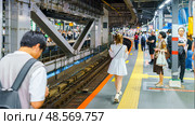 Tokyo, Japan - Sep 30 2024, Panoramic view of the platform of the Japanese JR subway with people waiting for the train, in Shibuya Crossing district, Tokyo, Japan. Редакционное фото, фотограф Сергей Богомяко / Фотобанк Лори