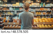 A young individual examines various grocery options, focusing on fresh foods and packaged goods, in a bustling market filled with bright colors. Стоковое AI-изображение, AI-художник Данила Большаков / Фотобанк Лори