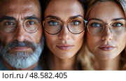 Three adults with distinct hairstyles and eyeglasses focus closely, showcasing their unique personalities and styles in bright indoor light. Стоковое AI-изображение, AI-художник Данила Большаков / Фотобанк Лори