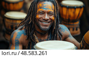 A happy musician with colorful face paint engages the crowd by skillfully drumming at an outdoor cultural festival filled with energy. Стоковое AI-изображение, AI-художник Данила Большаков / Фотобанк Лори